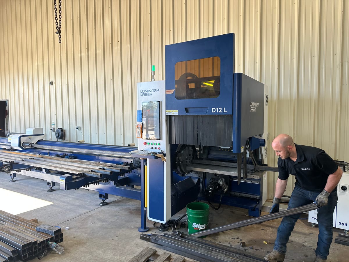 Tube laser cutting machine set up on a fabrication shop floor
