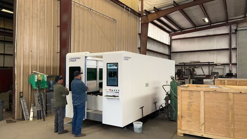 Enclosed LUMINARY LASER sheet metal cutting machine in a fabrication shop