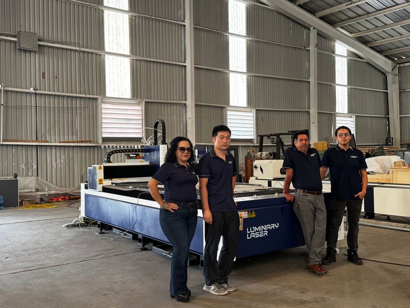 Fabrication team reviewing a tube laser cutting machine workflow