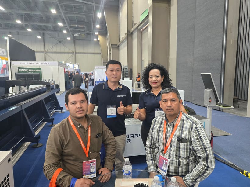 Tube laser cutting machine reviewed with fabrication buyers at a trade show